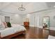 Bright main bedroom with hardwood floors, tray ceiling, with a fireplace and dresser at 4555 Peachtree Dunwoody Rd, Sandy Springs, GA 30342