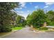Picturesque street view showcases a tree-lined road and green lawns, offering a glimpse of peaceful living at 4555 Peachtree Dunwoody Rd, Sandy Springs, GA 30342