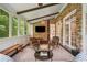Relaxing sunroom with brick walls, exposed beams, cozy seating, and French doors to the outside at 4555 Peachtree Dunwoody Rd, Sandy Springs, GA 30342