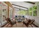 Cozy sunroom with brick accents, comfortable seating, and lots of natural light at 4555 Peachtree Dunwoody Rd, Sandy Springs, GA 30342