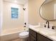 Bright bathroom featuring a tub with subway tile surround and a stylish vanity with marble countertop at 4665 Jersey Walnut Grove Rd, Covington, GA 30014