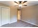 This bedroom has neutral walls, a ceiling fan, vinyl flooring and large closet for storage at 4665 Jersey Walnut Grove Rd, Covington, GA 30014