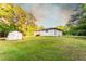 A house with a shed, offering a blend of comfort and utility against a backdrop of mature trees at 4665 Jersey Walnut Grove Rd, Covington, GA 30014