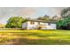 Charming home featuring a back deck and a spacious lawn surrounded by a lush green landscape at 4665 Jersey Walnut Grove Rd, Covington, GA 30014