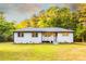 Charming single story home with a welcoming front porch and a well maintained lawn with mature landscaping at 4665 Jersey Walnut Grove Rd, Covington, GA 30014