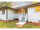 Close up of a home featuring a charming gray porch, new landscaping and a well-manicured lawn at 4665 Jersey Walnut Grove Rd, Covington, GA 30014