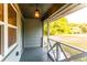 View of a covered front porch with a hanging lantern and white railing overlooking a grassy yard at 4665 Jersey Walnut Grove Rd, Covington, GA 30014
