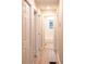 Hallway with multiple closets and doorways leading to rooms, including the bathroom with tiled walls at 4665 Jersey Walnut Grove Rd, Covington, GA 30014
