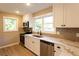 Modern kitchen featuring stainless steel appliances, granite countertops, white cabinets and ample natural light at 4665 Jersey Walnut Grove Rd, Covington, GA 30014
