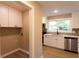 View of the kitchen and laundry area that offers great layout and functionality at 4665 Jersey Walnut Grove Rd, Covington, GA 30014