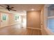 Bright open-concept living room showcasing new flooring and neutral paint with a ceiling fan and chandelier at 4665 Jersey Walnut Grove Rd, Covington, GA 30014