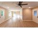 Bright open-concept living room showcasing new flooring and neutral paint with a ceiling fan and chandelier at 4665 Jersey Walnut Grove Rd, Covington, GA 30014