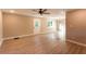 Bright open-concept living room showcasing new flooring and neutral paint with a ceiling fan and chandelier at 4665 Jersey Walnut Grove Rd, Covington, GA 30014