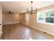 Spacious living room features modern light fixture, fresh paint, and beautiful wood flooring at 4665 Jersey Walnut Grove Rd, Covington, GA 30014
