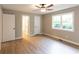 Bright main bedroom featuring two closets, fresh paint, and a large window at 4665 Jersey Walnut Grove Rd, Covington, GA 30014