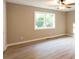Inviting main bedroom featuring a ceiling fan, fresh paint, and a large window at 4665 Jersey Walnut Grove Rd, Covington, GA 30014