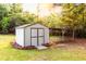 A well-maintained shed stands on a lush green lawn, adding functional charm to the outdoor space at 4665 Jersey Walnut Grove Rd, Covington, GA 30014