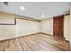 Unfinished basement area featuring vinyl floors, paneled walls, and a dark paneled closet at 4805 Forest Way Ct, Marietta, GA 30066
