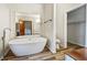 Bright bathroom featuring a freestanding tub, walk-in closet, and tile flooring at 4805 Forest Way Ct, Marietta, GA 30066