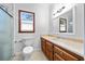 Bathroom featuring white toilet, wood cabinets, tile flooring, vanity and a shower at 4805 Forest Way Ct, Marietta, GA 30066