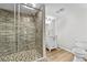 The bathroom boasts a tiled glass shower, vinyl flooring, a white vanity, and a commode at 4805 Forest Way Ct, Marietta, GA 30066