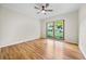Bright bedroom with hardwood floors, ceiling fan and large picture windows overlooking a spacious green lawn at 4805 Forest Way Ct, Marietta, GA 30066