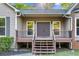 Inviting front entrance featuring double doors and a covered porch with manicured landscaping at 4805 Forest Way Ct, Marietta, GA 30066