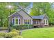 Beautifully landscaped front yard of a ranch home with brick accents and a cozy entrance at 4805 Forest Way Ct, Marietta, GA 30066
