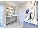Bright bathroom with double vanities, gray cabinets, and stylish decor at 606 Broadview Ne Ter, Atlanta, GA 30324