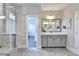 Bathroom with shower, double vanities, and an open doorway to the walk-in closet at 606 Broadview Ne Ter, Atlanta, GA 30324