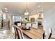 Dining room open to the kitchen and living room, hardwood floors and staircase to the second floor at 606 Broadview Ne Ter, Atlanta, GA 30324
