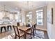 Dining room and kitchen with a wooden table for six, hardwood floors, and stainless steel appliances at 606 Broadview Ne Ter, Atlanta, GA 30324