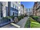Exterior street view of modern townhomes with walkways, bench seating and manicured green spaces at 606 Broadview Ne Ter, Atlanta, GA 30324