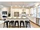 Stylish kitchen featuring an island with bar stools, stainless steel appliances, and modern pendant lighting at 606 Broadview Ne Ter, Atlanta, GA 30324