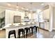Bright kitchen with white cabinets, stainless steel appliances, island with seating and modern pendant lights at 606 Broadview Ne Ter, Atlanta, GA 30324
