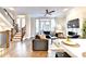Living room featuring hardwood floors, open staircase, and outdoor balcony at 606 Broadview Ne Ter, Atlanta, GA 30324