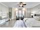 Spacious main bedroom with sitting area, hardwood floors, ceiling fan and large windows at 606 Broadview Ne Ter, Atlanta, GA 30324