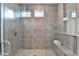 Modern bathroom features large, tiled shower with glass door and built-in bench at 606 Broadview Ne Ter, Atlanta, GA 30324