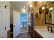 Bathroom with a detailed backsplash, granite countertop, and dark wood cabinets at 731 Sacketts Ct, Lawrenceville, GA 30043