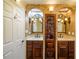 Beautiful bathroom featuring dual sinks, dark wood cabinets, and decorative lighting at 731 Sacketts Ct, Lawrenceville, GA 30043