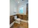 Bathroom with mosaic style lower wall, tiled floors, a large window, and modern fixtures at 731 Sacketts Ct, Lawrenceville, GA 30043