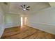 Bedroom featuring hardwood floors, large windows, and a tray ceiling with ceiling fan at 731 Sacketts Ct, Lawrenceville, GA 30043