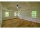 Spacious bedroom with tray ceiling, hardwood floors, and large windows at 731 Sacketts Ct, Lawrenceville, GA 30043