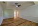 Bedroom featuring hardwood floors, large windows, and a tray ceiling with ceiling fan at 731 Sacketts Ct, Lawrenceville, GA 30043