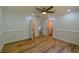 Bedroom with hardwood floors, ceiling fan, and access to closets and other rooms at 731 Sacketts Ct, Lawrenceville, GA 30043