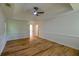 Light-filled bedroom with tray ceiling, hardwood floors, and neutral walls at 731 Sacketts Ct, Lawrenceville, GA 30043