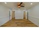 Large bedroom with wood floors, crown molding, ceiling fan, and access to closets and other rooms at 731 Sacketts Ct, Lawrenceville, GA 30043
