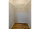 A walk-in closet featuring wire shelving and hardwood floors at 731 Sacketts Ct, Lawrenceville, GA 30043