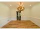 Dining room featuring hardwood floors, molding, and an elegant chandelier at 731 Sacketts Ct, Lawrenceville, GA 30043