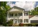 Charming two-story home featuring a well-manicured lawn and an attached two-car garage with dark grey doors at 731 Sacketts Ct, Lawrenceville, GA 30043